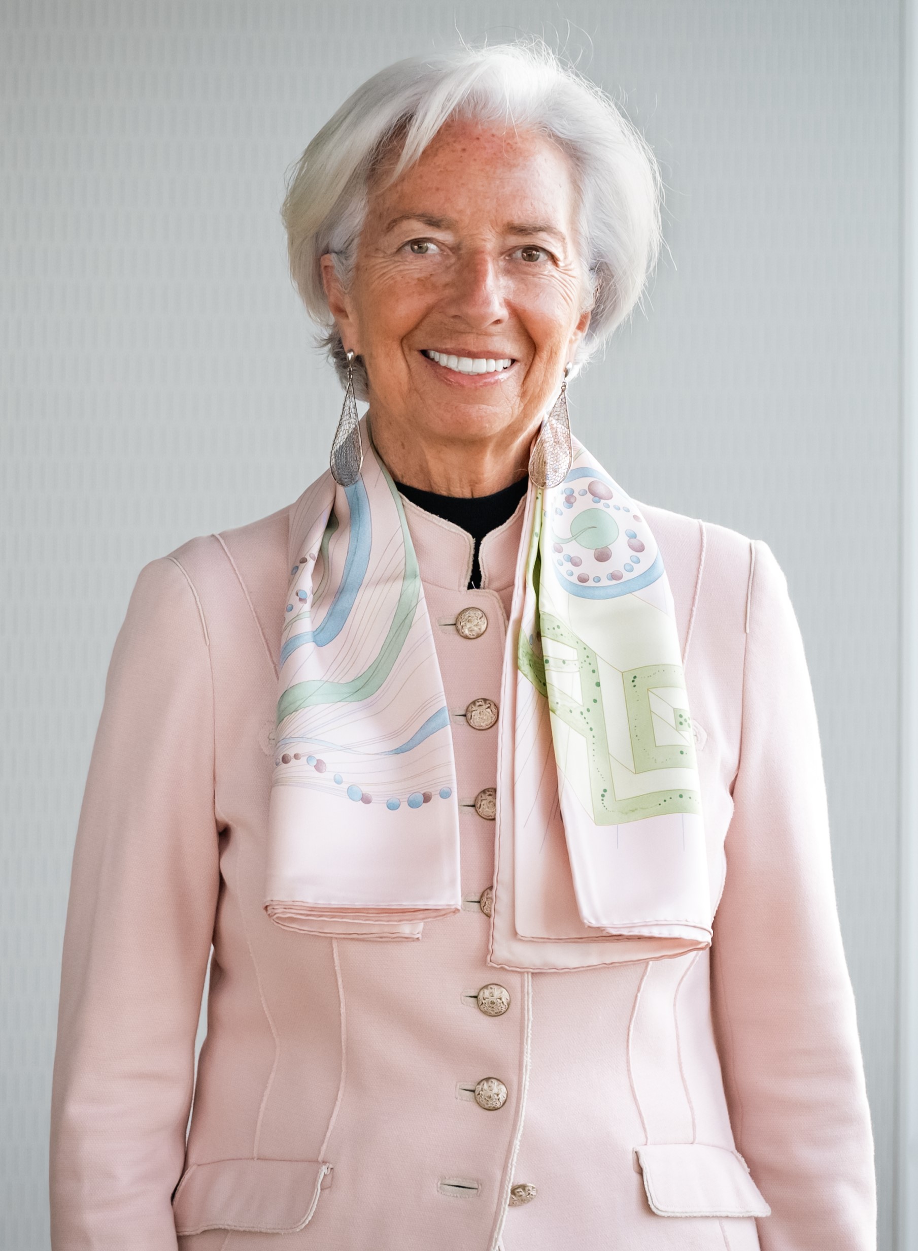 A person wearing a pink jacket and scarf
Description automatically generated